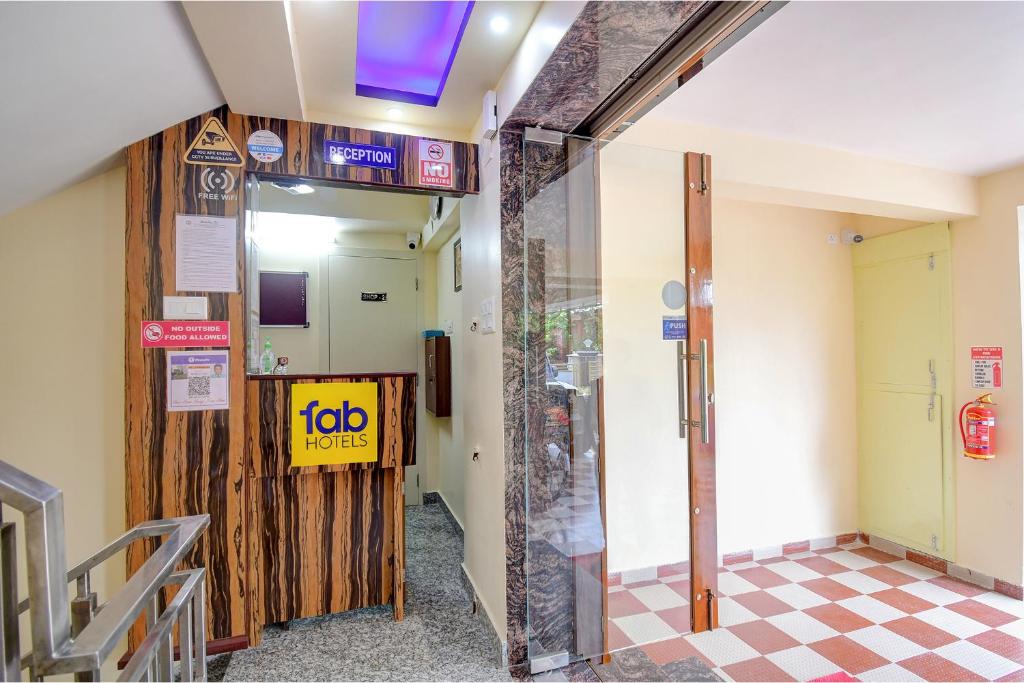 a lobby of a building with a job sign on the wall at FabHotel Anchorage Inn in Kolkata
