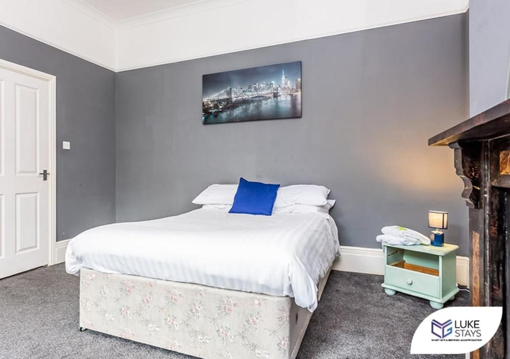 a bedroom with a bed and a tv on the wall at Luke Stays - Brandling Street in Monkwearmouth