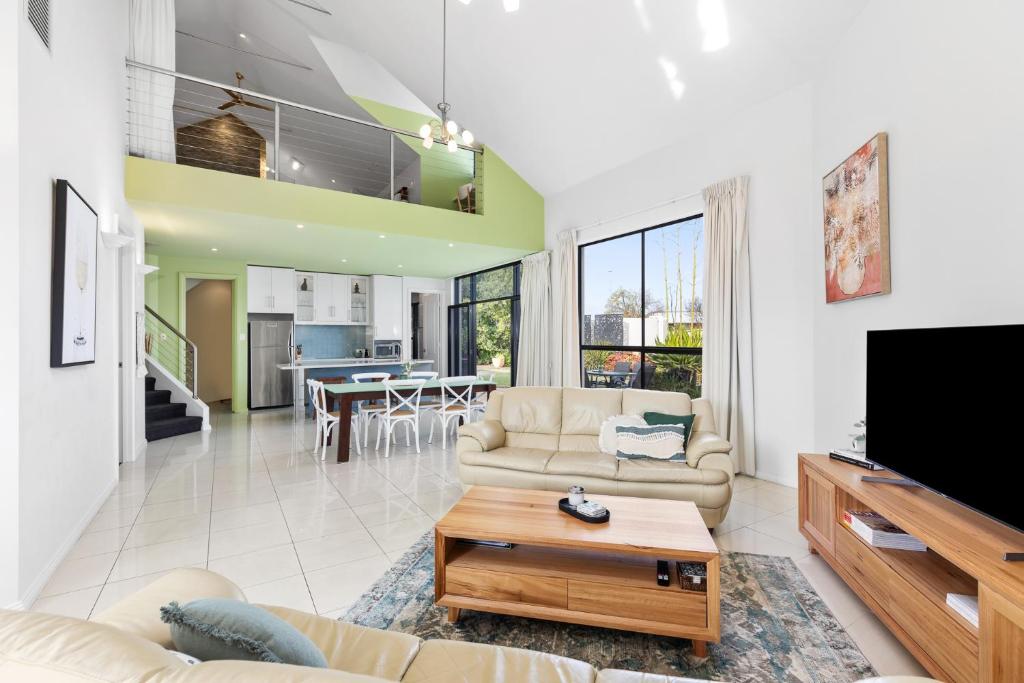 a living room with a couch and a tv at Merlot Verdelho Townhouses in Penola