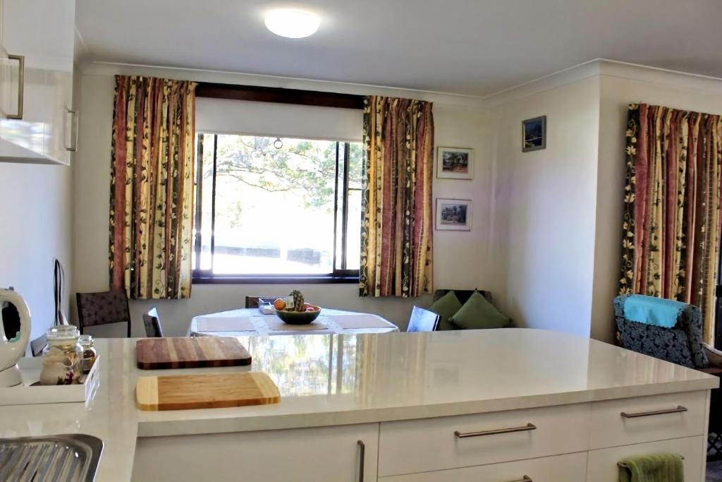 a kitchen with a large window and a table at Sanctuary Court Unit 4 in Gold Coast