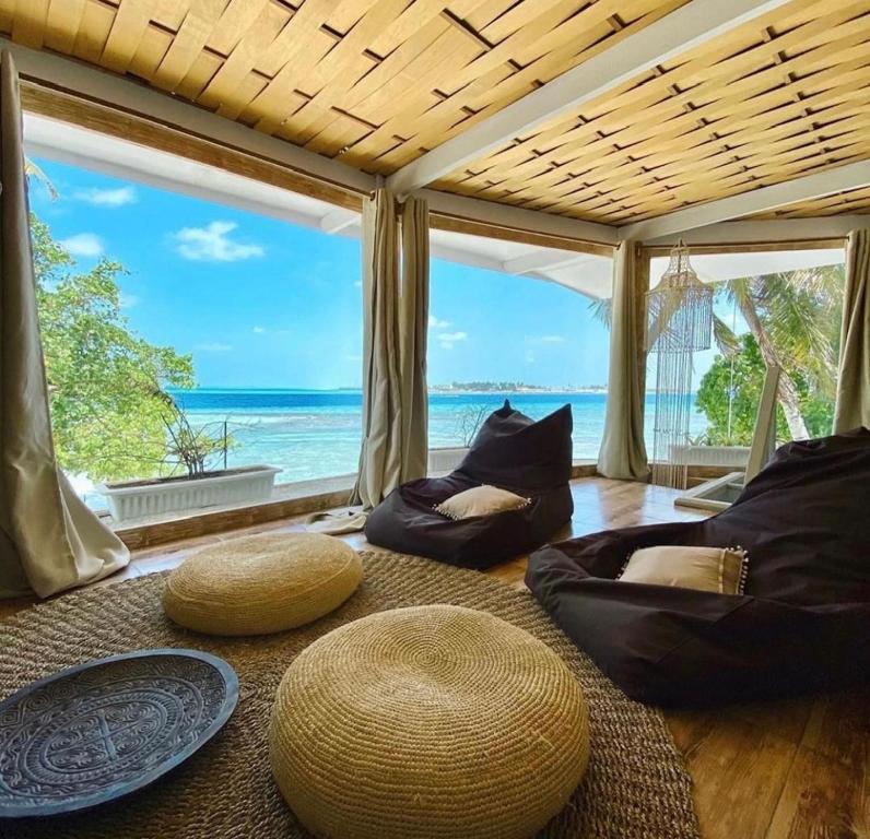 a living room with a view of the ocean at Samura Maldives Guest House Thulusdhoo in Thulusdhoo