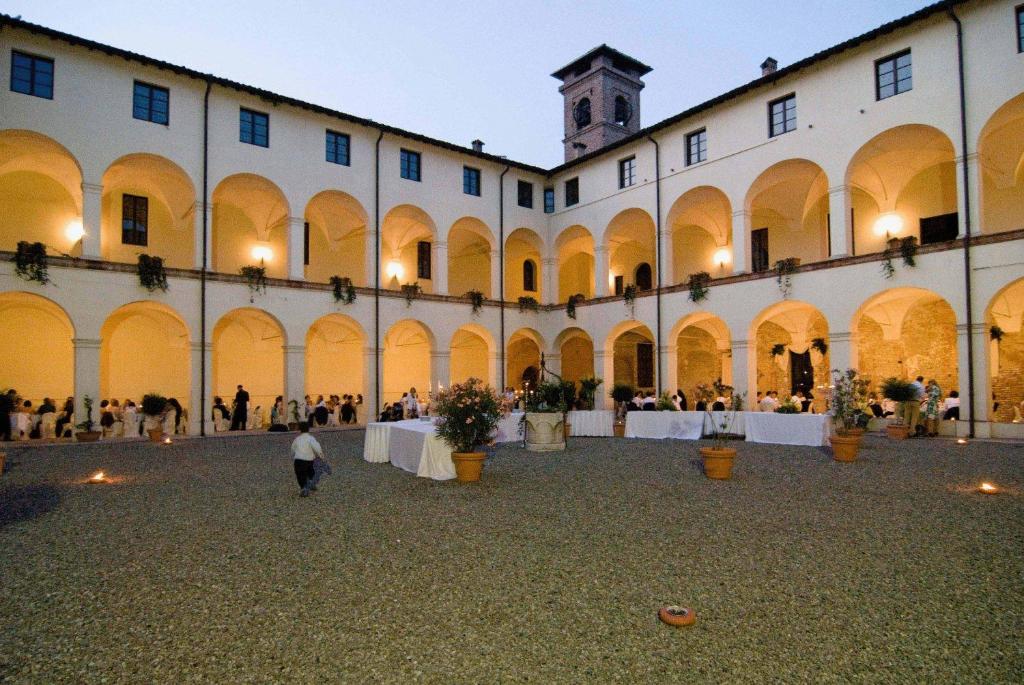 a large building with a crowd of people in it at Relais Fontevivo in Fontevivo
