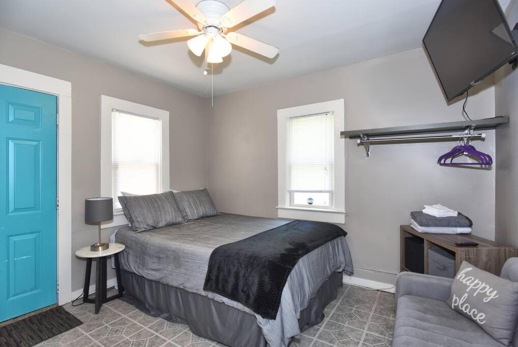 a bedroom with a bed and a ceiling fan at CHERRY ST LITTLE LOVE HOUSE* SHOP*DINE* RT 66*EXPO CENTER*BOK*DOWNTOWN in Tulsa