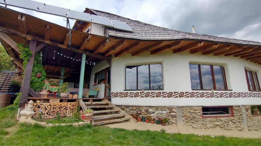 a house with a wooden roof and a porch at Casa cu Soare 