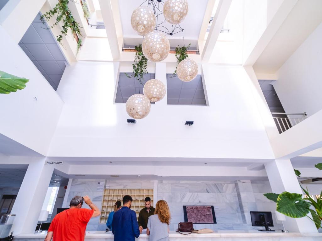 a group of people standing in the lobby of a building at Hotel Don Ignacio in San José