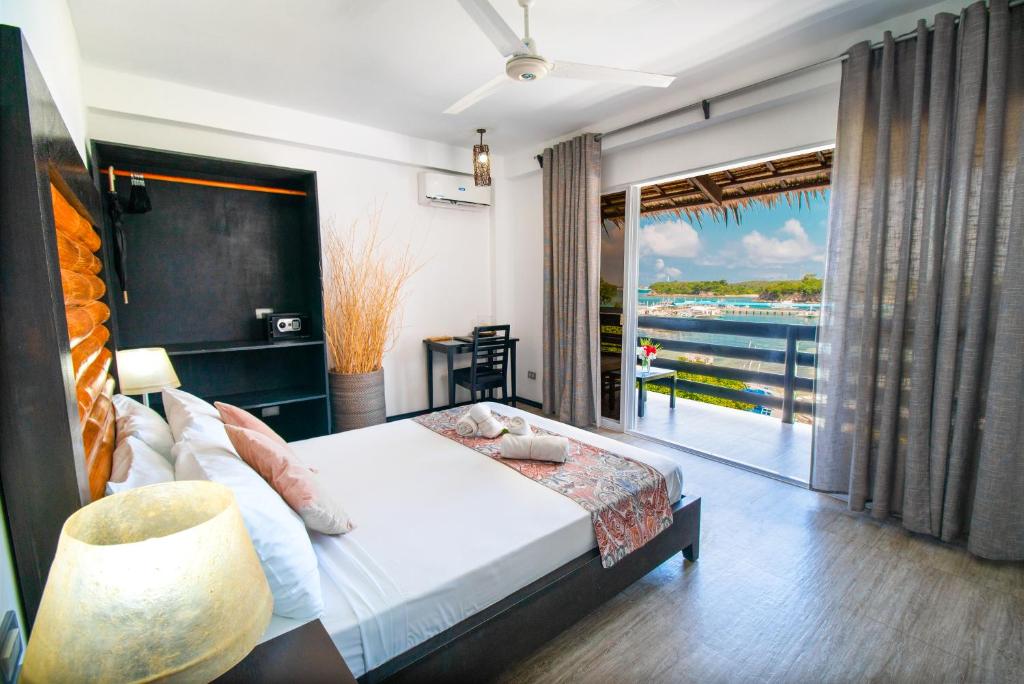 a bedroom with a bed and a view of the water at Blanco Beach Resort Malapascua in Malapascua Island
