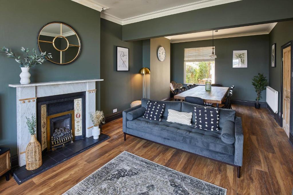 a living room with a couch and a fireplace at Host & Stay - Raven House in Robin Hood's Bay