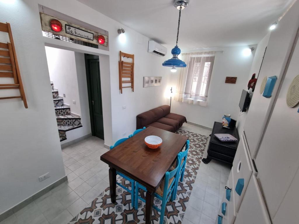 a living room with a table and a couch at Casa viotti Le fuoriserie in Palermo