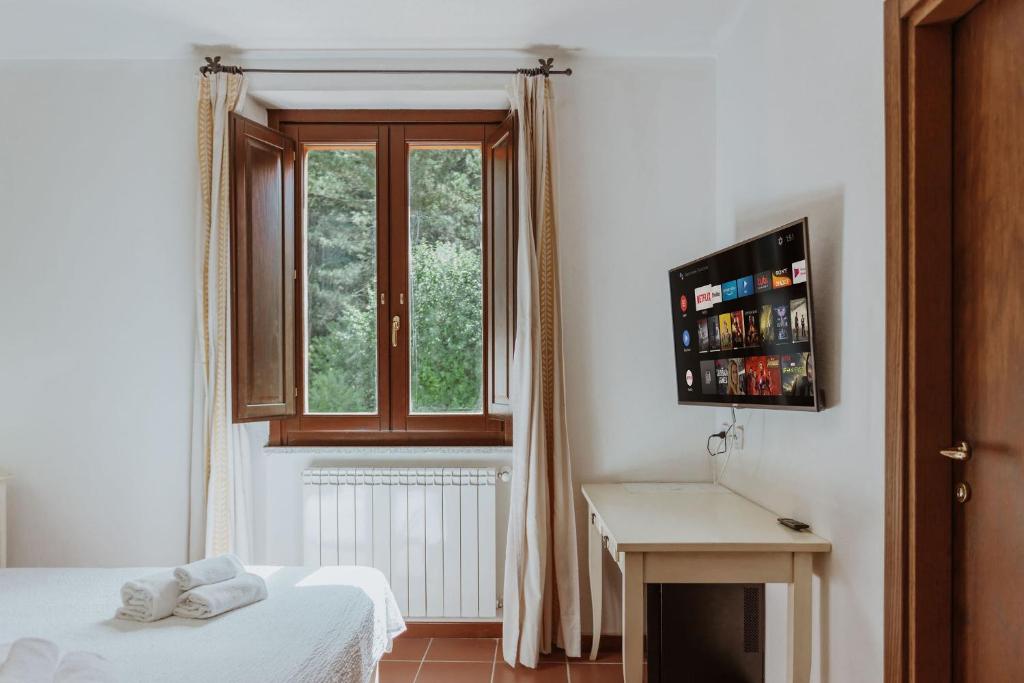 A bed or beds in a room at Vallicciola Nature Hotel
