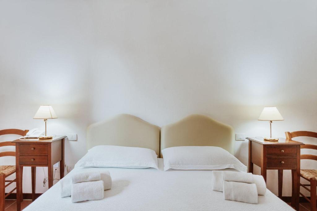 A bed or beds in a room at Vallicciola Nature Hotel