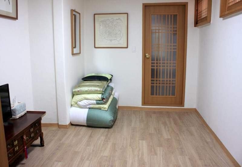 a living room with a couch and a door at Yeon Dang Guesthouse in Seoul