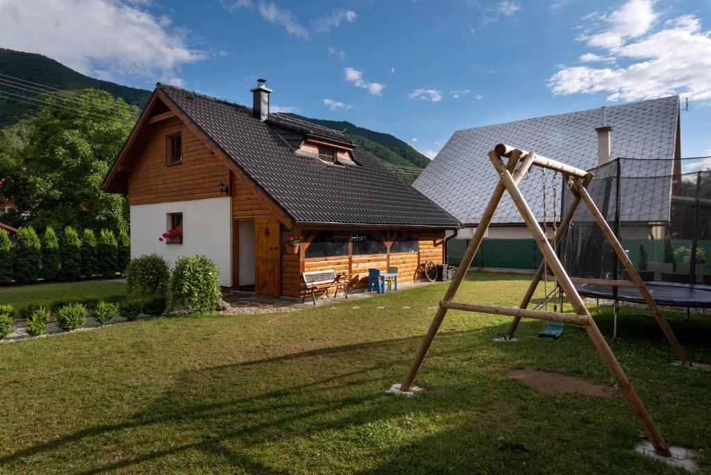 a playground in front of a wooden house at Chalupa Anička - Terchová in Terchová