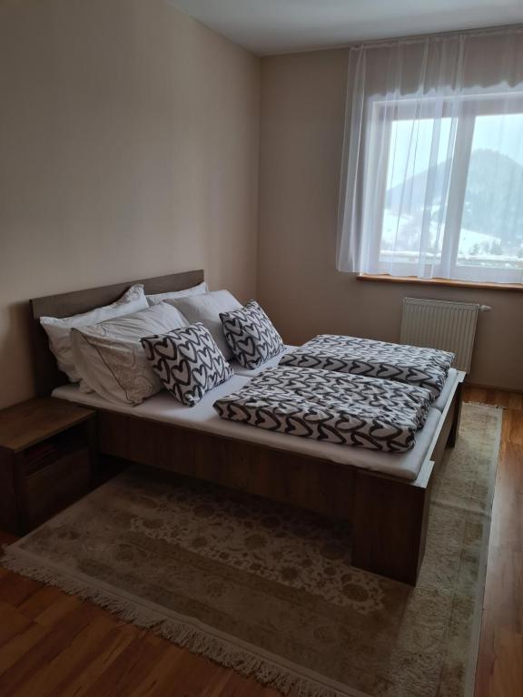 a large bed in a bedroom with a window at Apartman 508 Residence in Donovaly