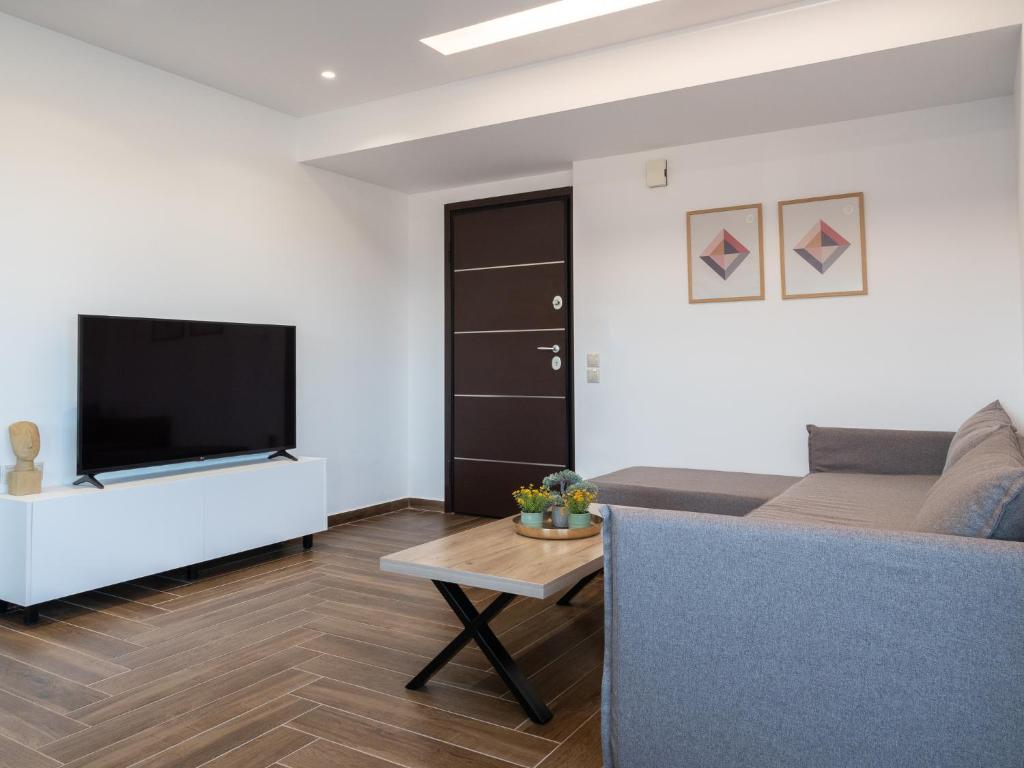 a living room with a flat screen tv and a couch at Apartment Santa Marina 4 in Asgourou