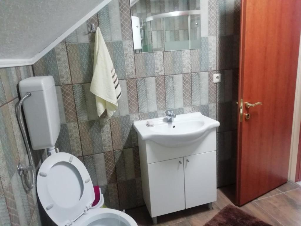 a bathroom with a toilet and a sink at Apartman Salus in Tuzla