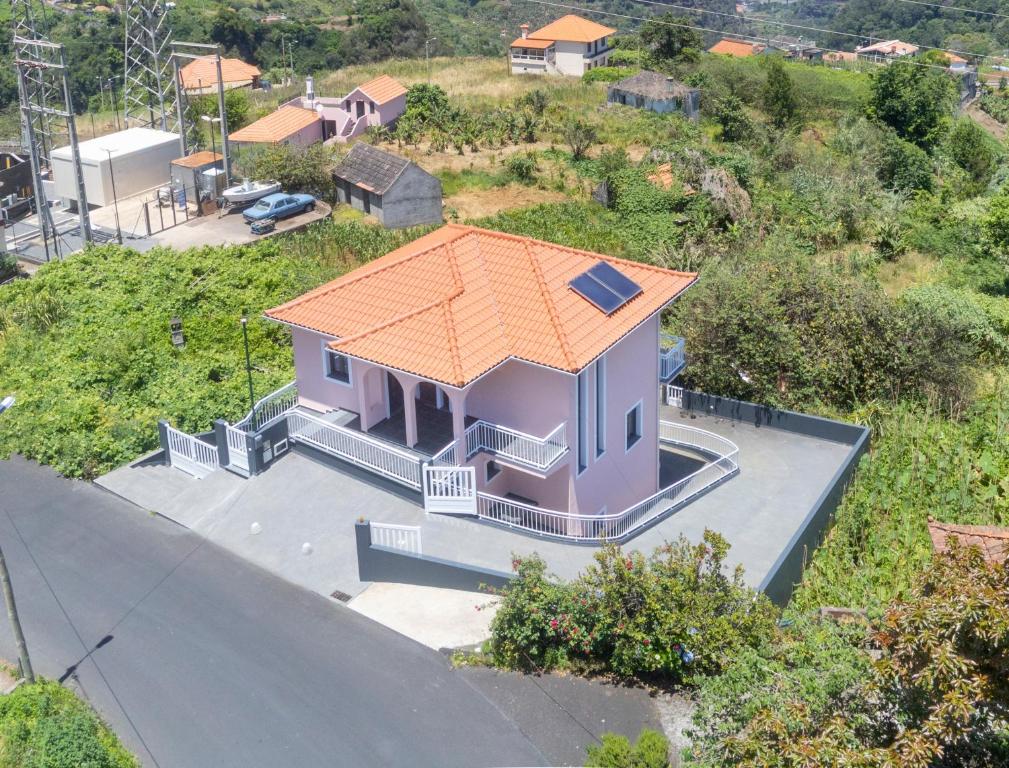 a small purple house with an orange roof at Villa Pearl in Santana