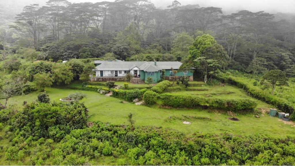 an aerial view of a house on a green field at Sir John's Bungalow in Matale