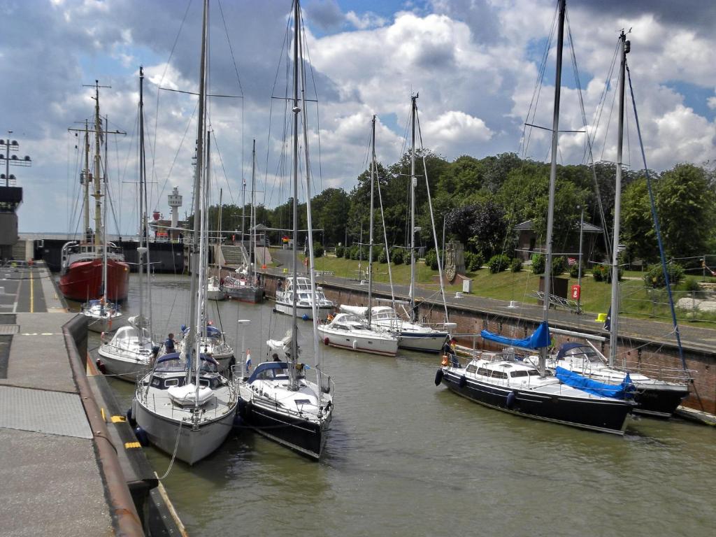 a group of boats docked in a harbor at Ferienwohnung an Schleusenanlage NOK in Brunsbüttel