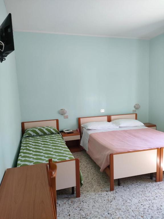 Postel nebo postele na pokoji v ubytování Albergo La Primula