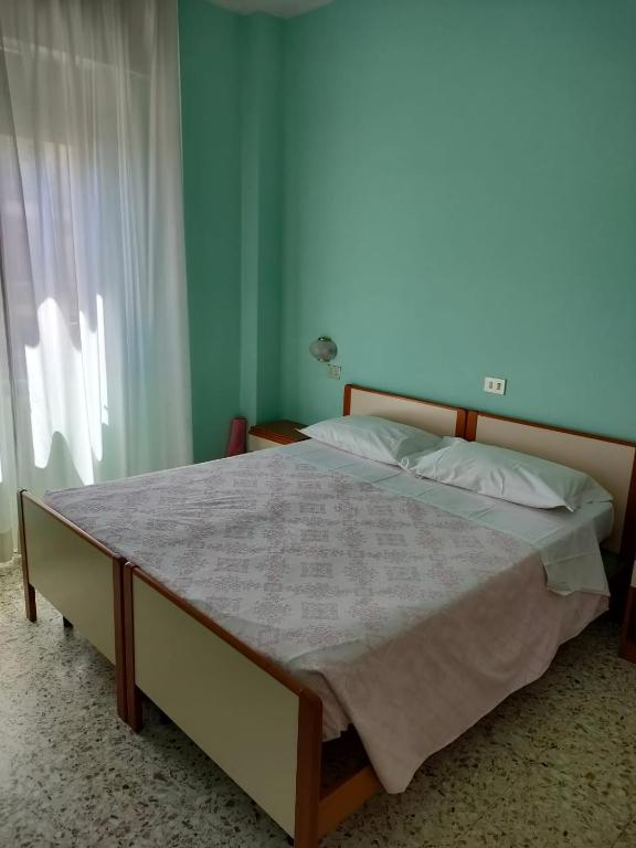Postel nebo postele na pokoji v ubytování Albergo La Primula