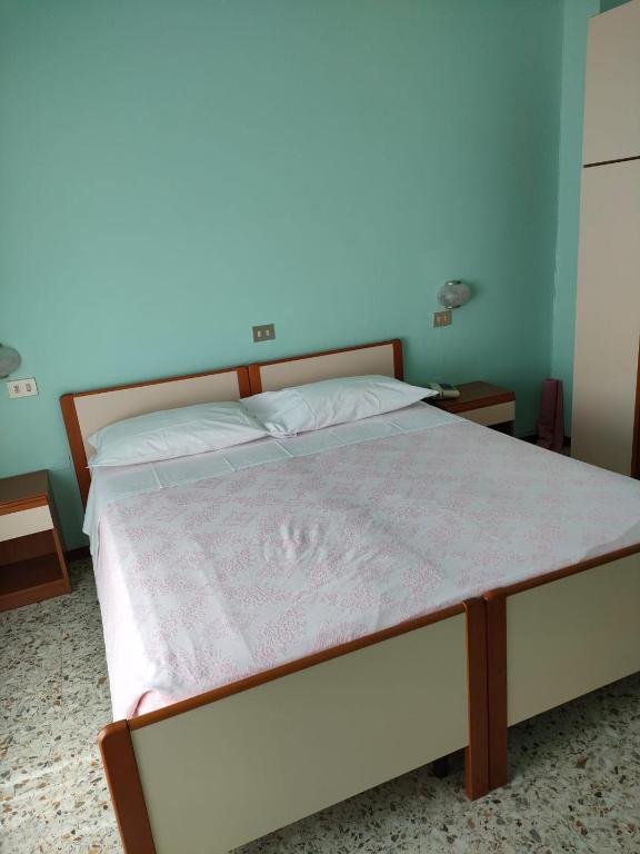 Postel nebo postele na pokoji v ubytování Albergo La Primula