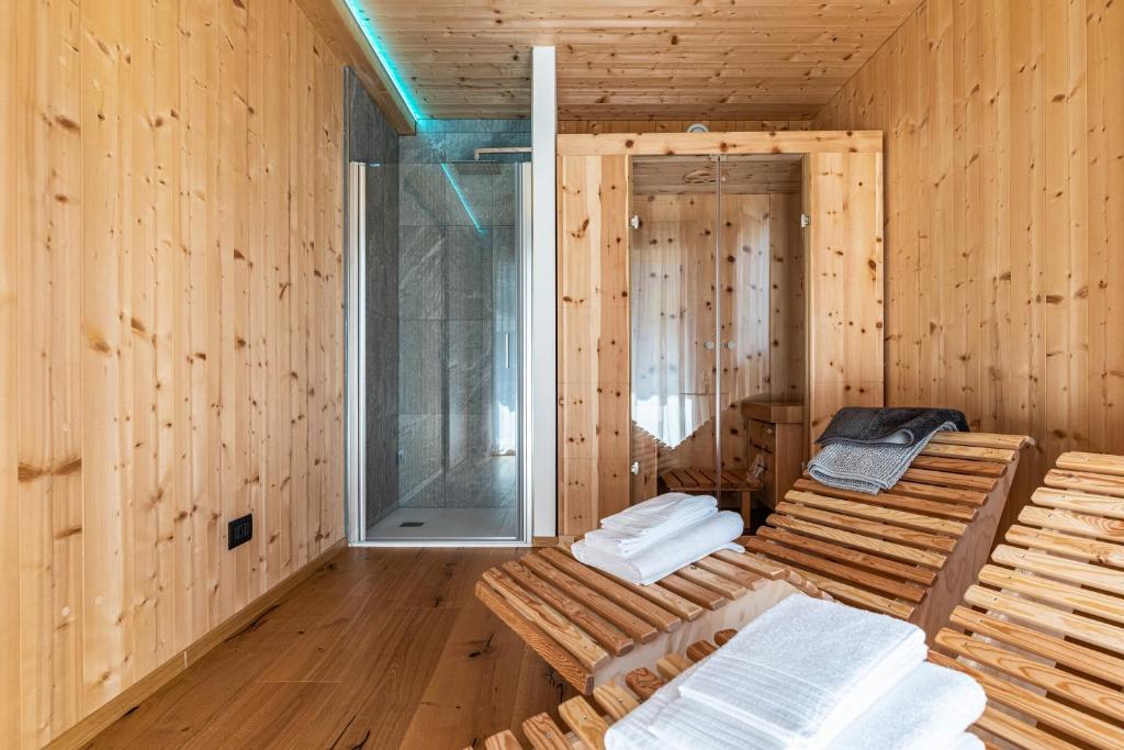 a sauna with wooden walls and a glass door at Ciasa Fatati in Pinzolo