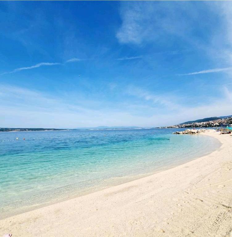a beach with blue water and a blue sky at Mobile Home Mar Vista Selce in Selce