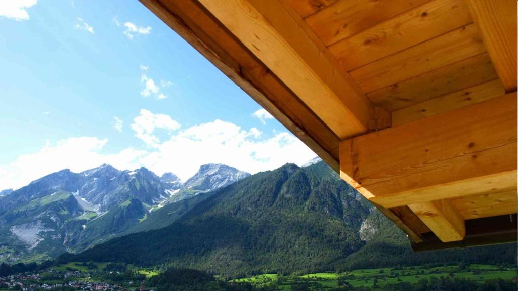 a view of a mountain range from a wooden house at Appartements Oberdorfer in Landeck
