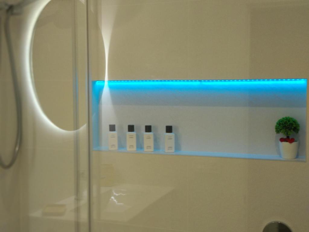 bagno con doccia e luce blu di Oviedo Centro a Oviedo