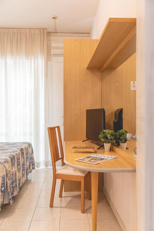Postel nebo postele na pokoji v ubytování Hotel Loretta & Dependance