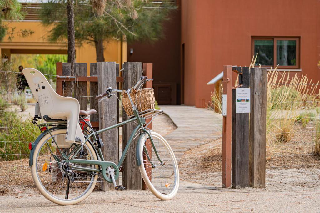 a bike parked next to a wooden fence at Pestana Troia Eco-Resort & Residences in Troia