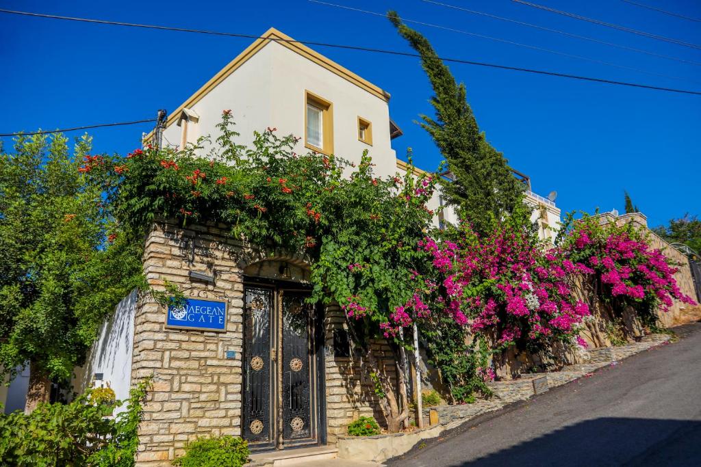 a house with flowers on the side of it at The Aegean Gate Hotel in Bodrum City