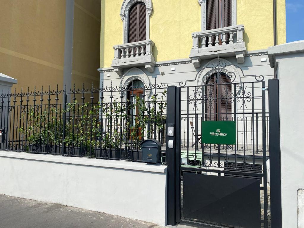 een zwarte poort voor een gebouw bij Villino Milano in Milaan