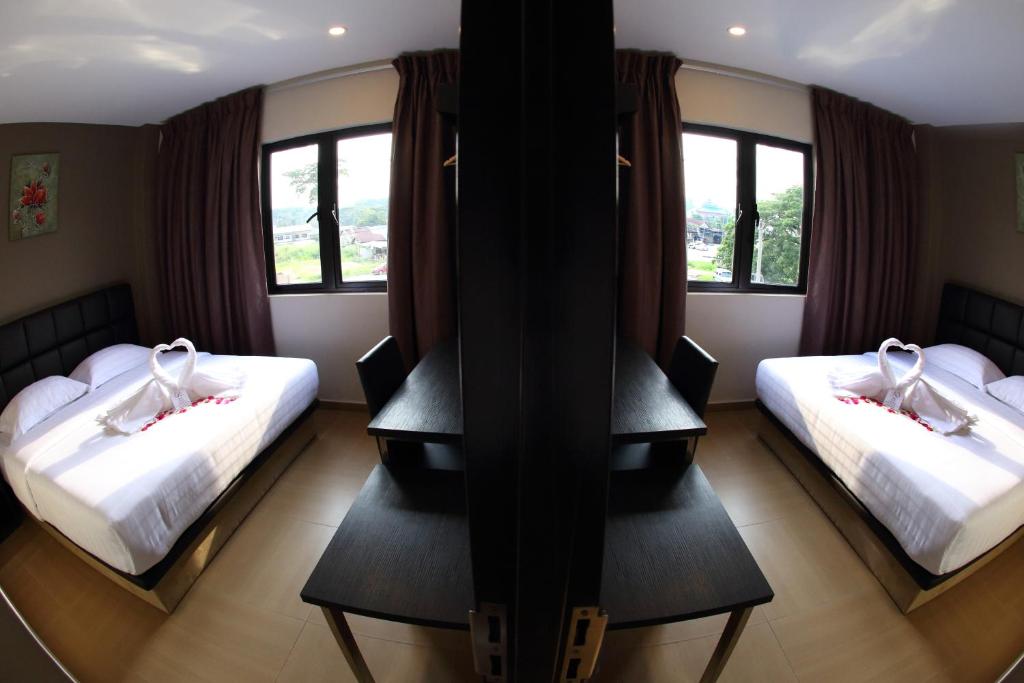Postel nebo postele na pokoji v ubytování GL Hotel Kluang