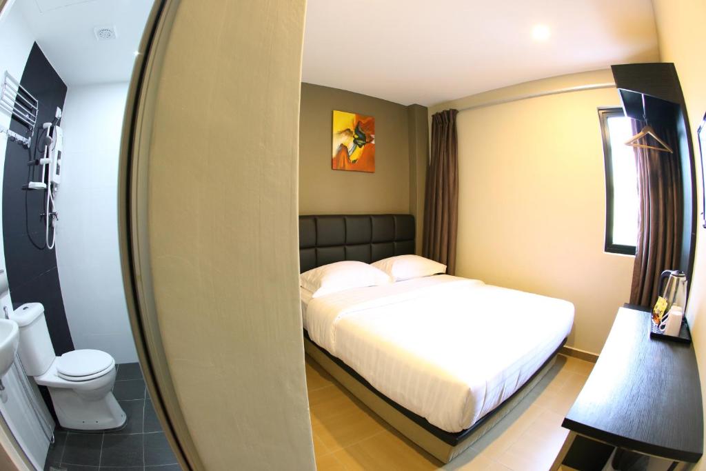 Postel nebo postele na pokoji v ubytování GL Hotel Kluang