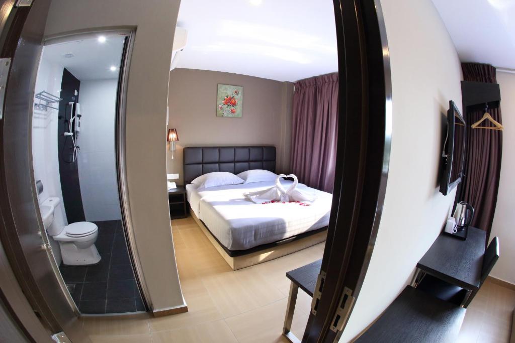 Postel nebo postele na pokoji v ubytování GL Hotel Kluang