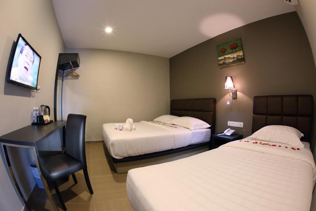 Postel nebo postele na pokoji v ubytování GL Hotel Kluang