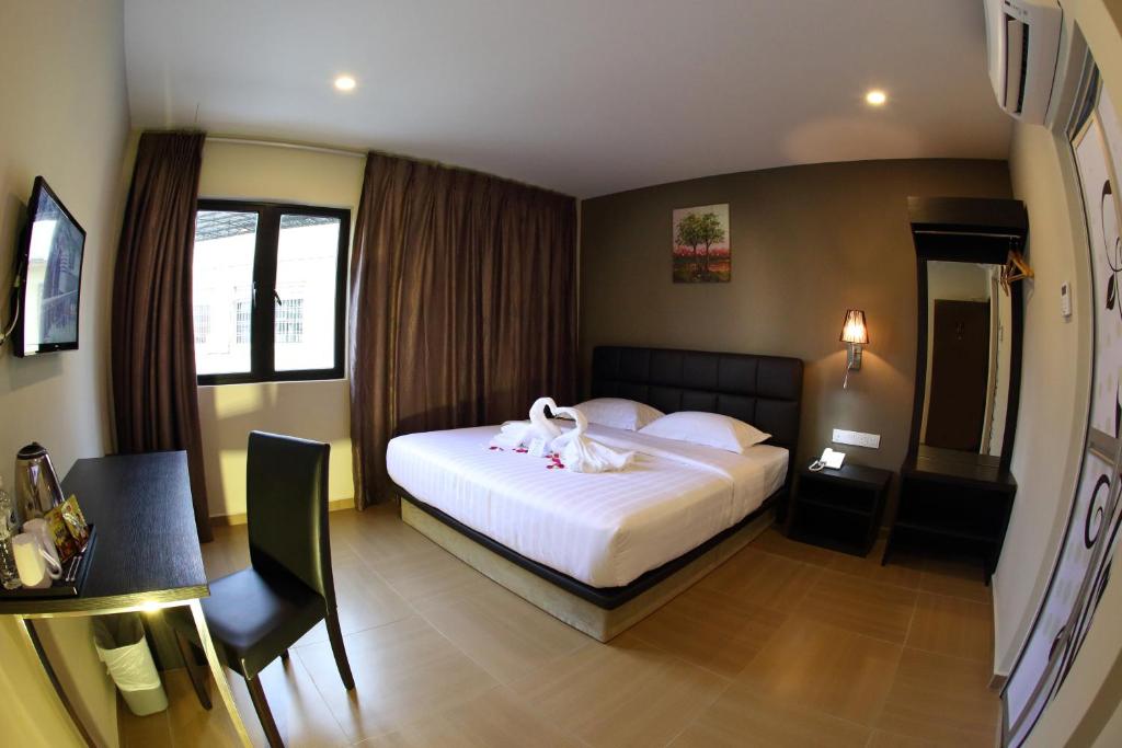Postel nebo postele na pokoji v ubytování GL Hotel Kluang