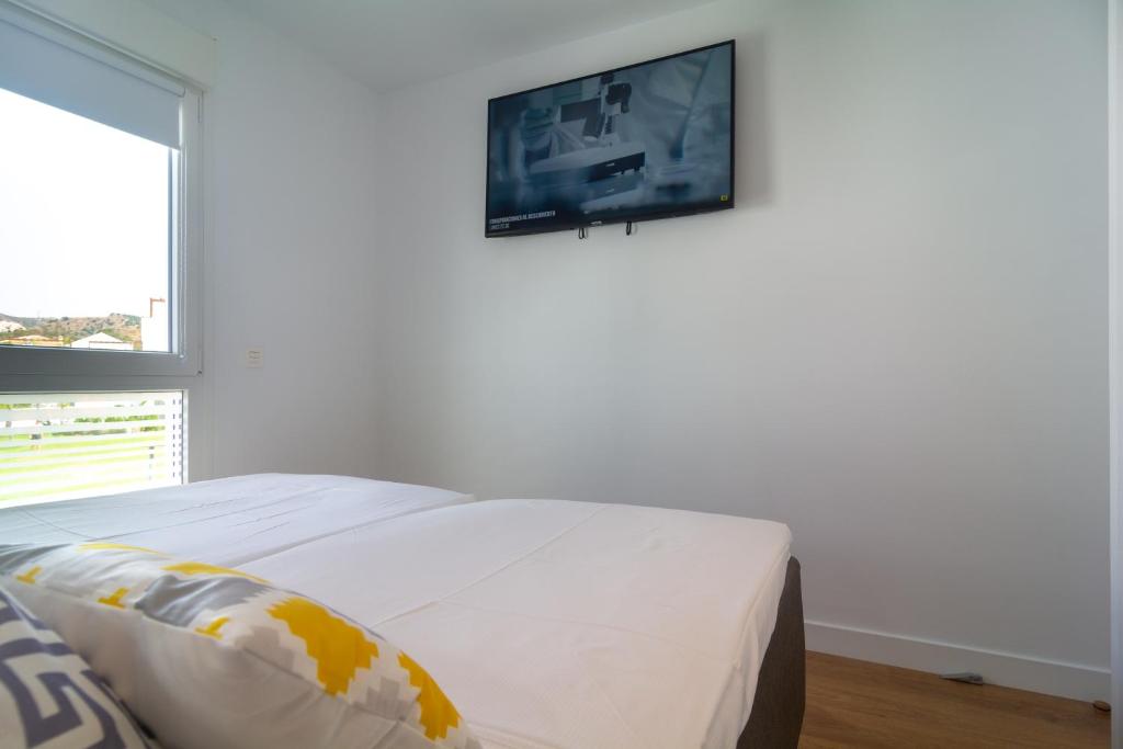 Televízia a/alebo spoločenská miestnosť v ubytovaní Townhouse El Romeral