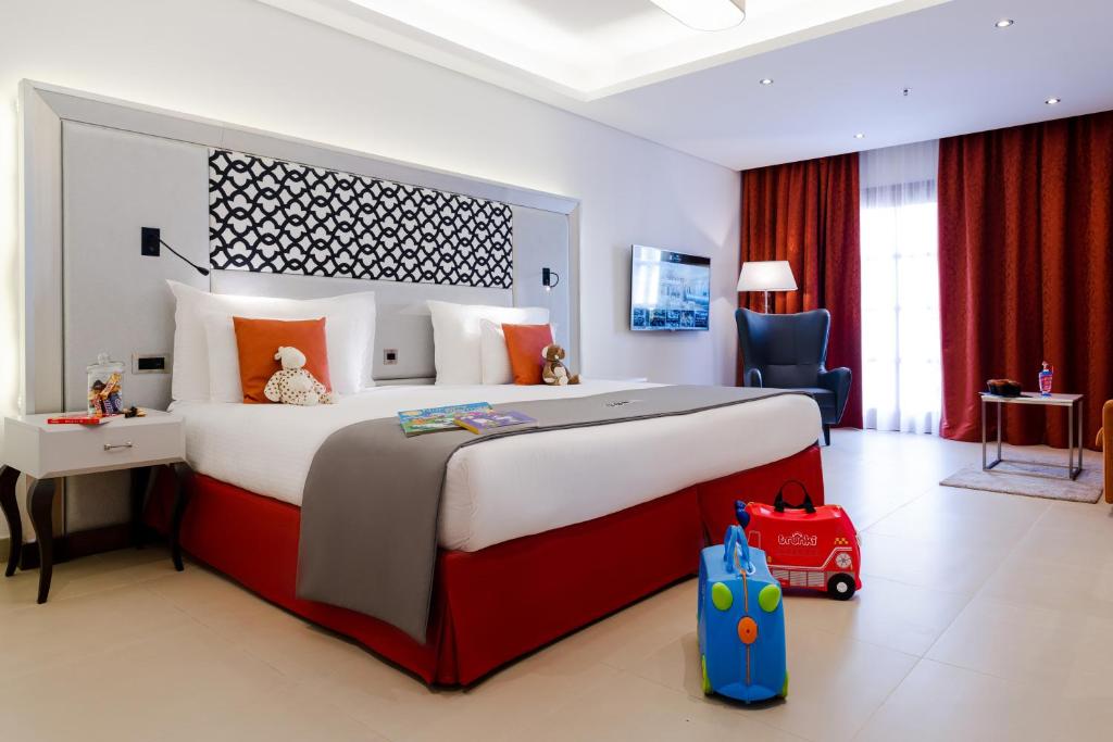 a bedroom with a large bed with a toy car on it at AX The Palace in Sliema