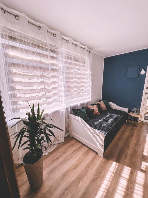 a bedroom with a bed and a window with a plant at Unicorn Hřensko in Hřensko