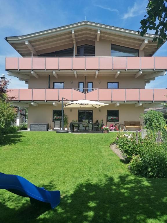 a large house with a lawn in front of it at Steigental in Kössen