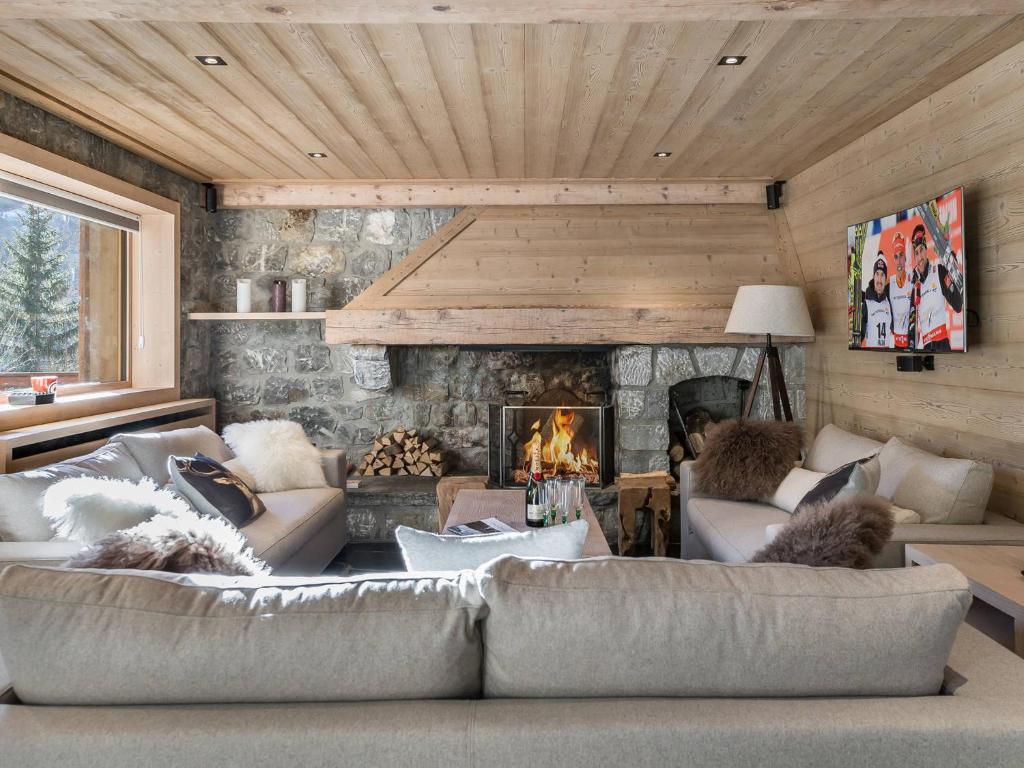 a living room with a couch and a fireplace at Chalet Méribel, 5 pièces, 11 personnes - FR-1-565-46 in Les Allues