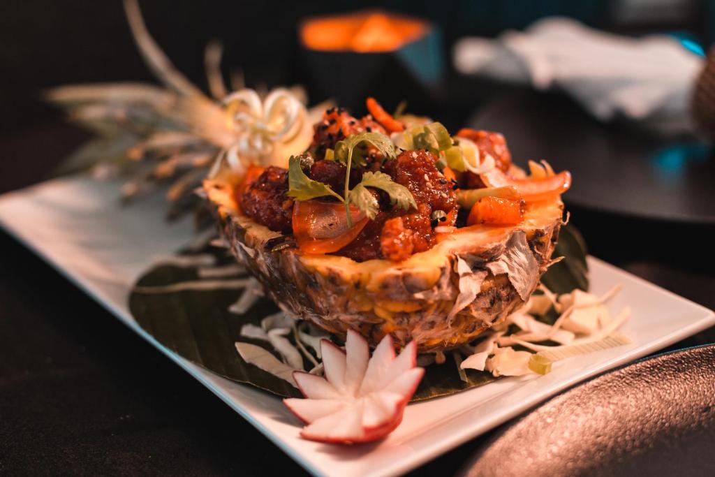 a dish of food on a plate on a table at AX The Palace in Sliema