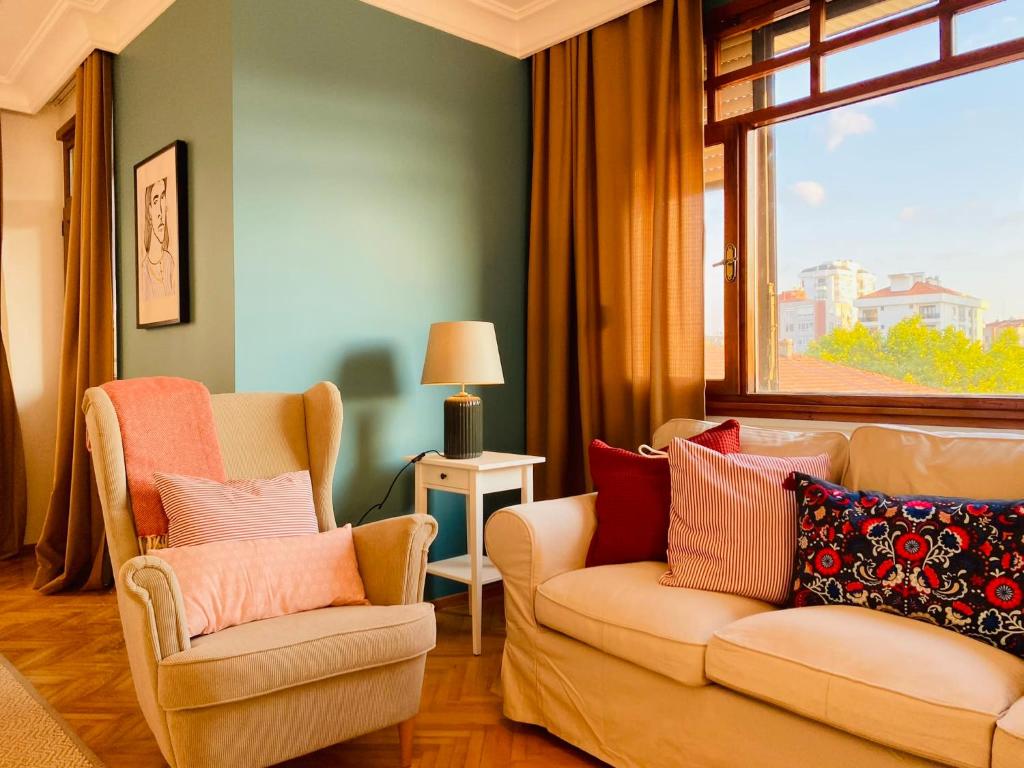 sala de estar con 2 sillas y ventana en Spacious Duplex Flat near Bagdat Street en Estambul