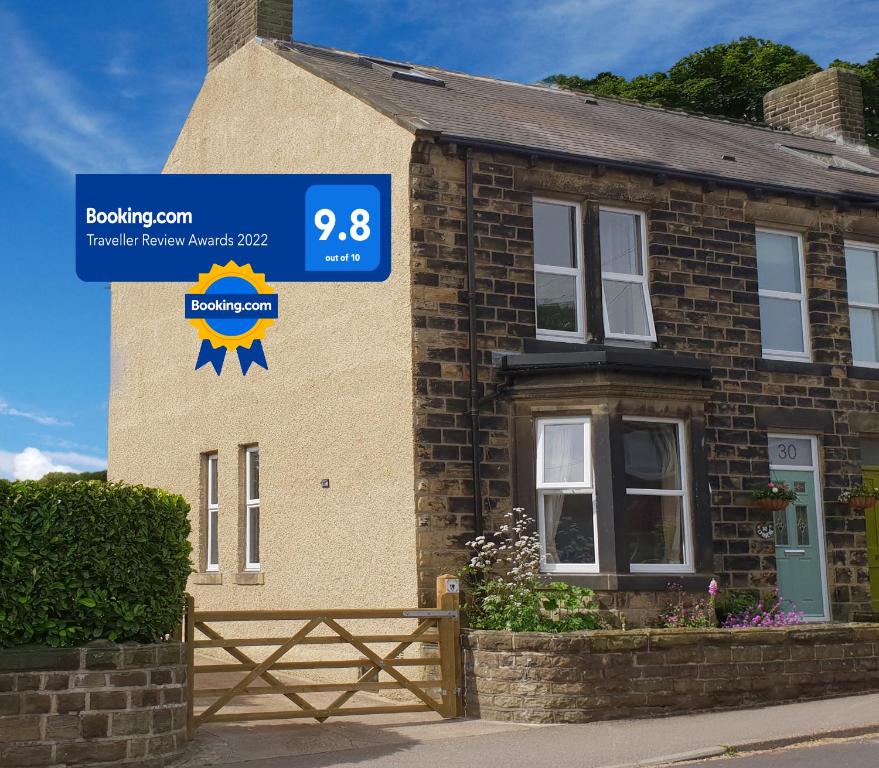 a house with a blue sign in front of it at Lyndene in Penistone