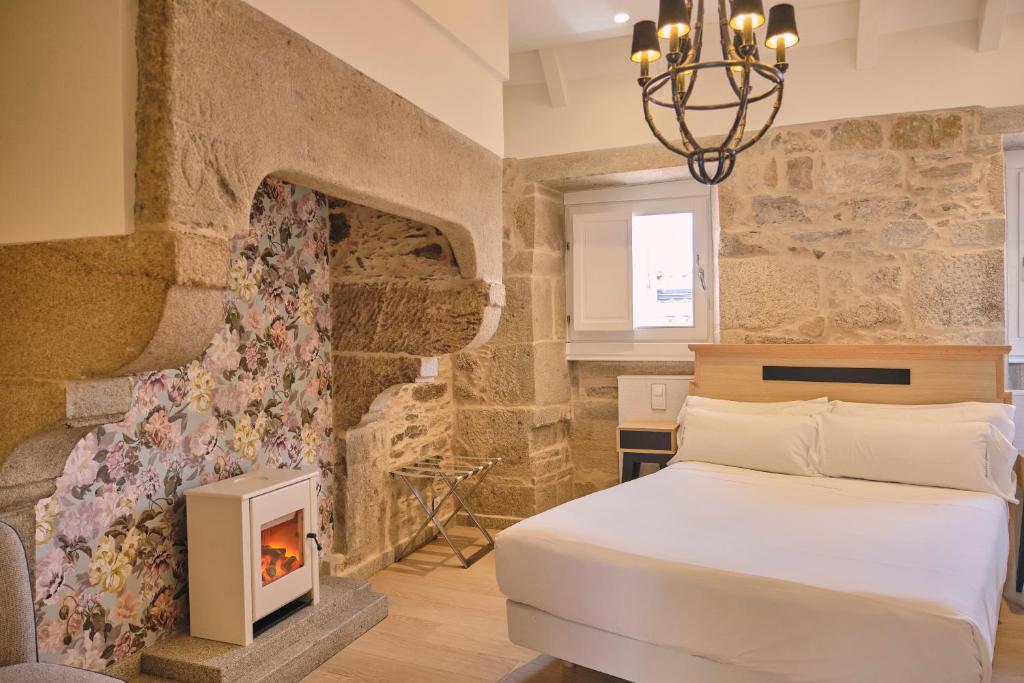 מיטה או מיטות בחדר ב-Hotel Praza Quintana