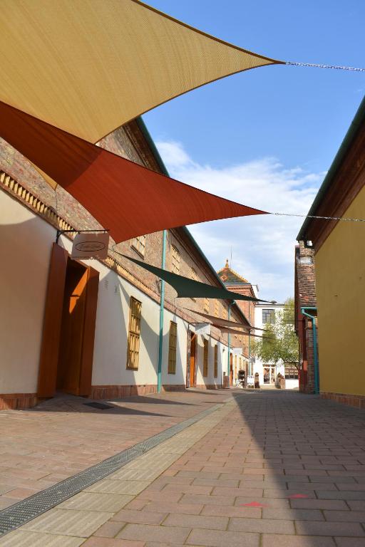 widok na pustą ulicę z markizami w obiekcie Zsolnay Negyed Vendégháza w mieście Pecz