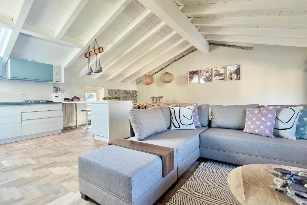 a living room with a couch and a table at Borgo dei Sogni - Unique Loft - Lago di Garda in San Felice del Benaco