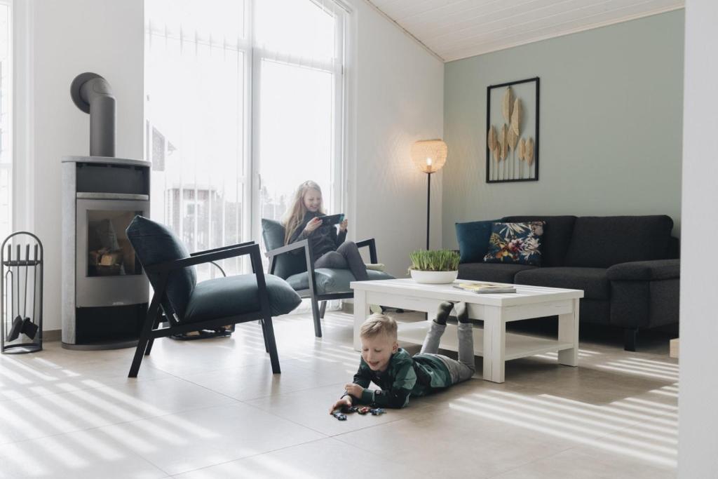 a baby crawling on the floor in a living room at SeeHus - Nordhorn in Nordhorn